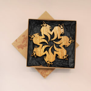 A round wooden kangaroo design trivet in a recycled card presentation box