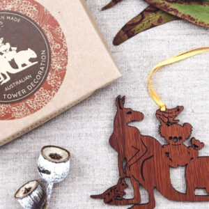 A wooden decoration featuring Australian animals. It is next to its recycled cardboard box.